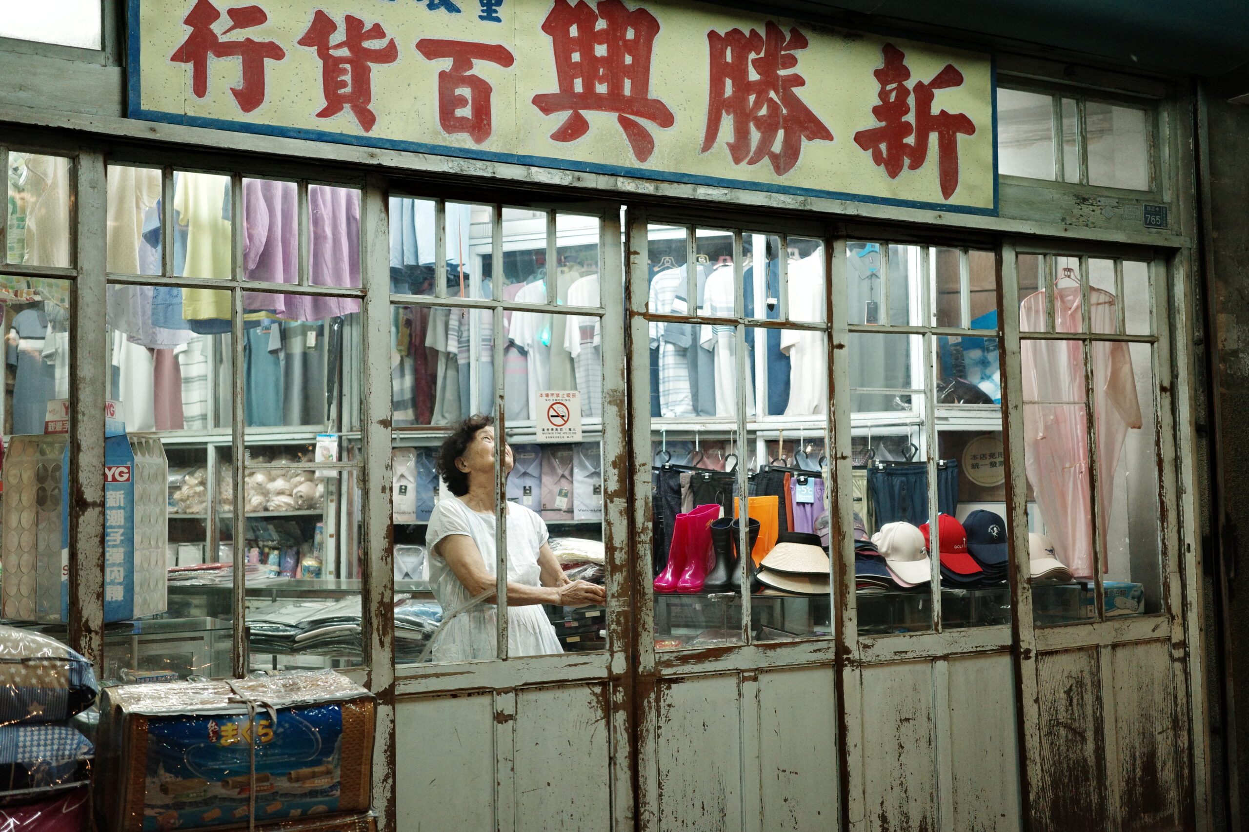 Old shop window with warm interior light breaking the night silence.